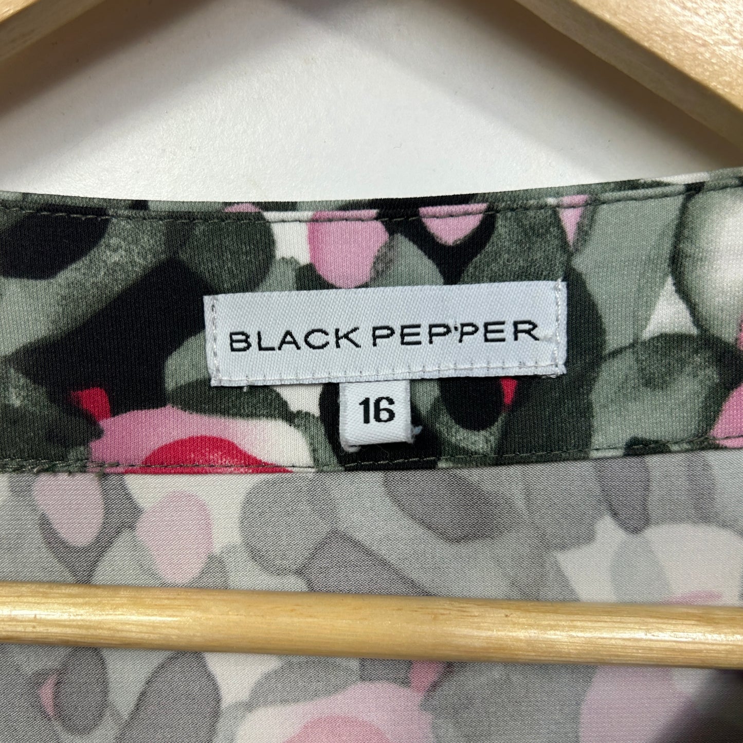 Black Pepper brand label size 16 on floral patterned fabric detail view