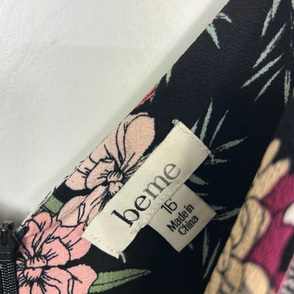 Black floral fabric detail view with pink flowers and benne label