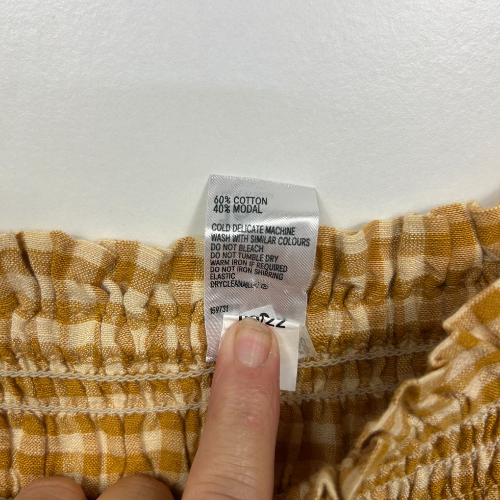 Yellow and white checked shorts label detail view