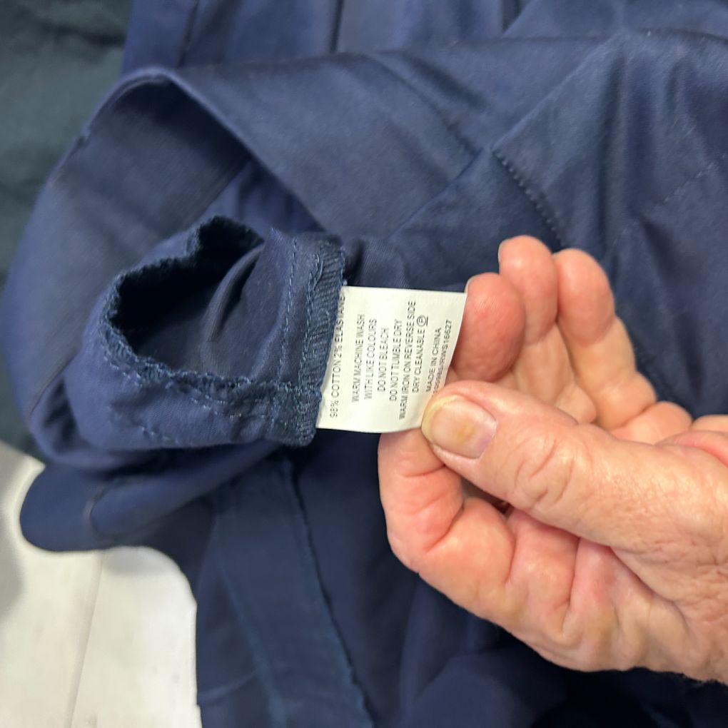 Navy jacket detail view showing label