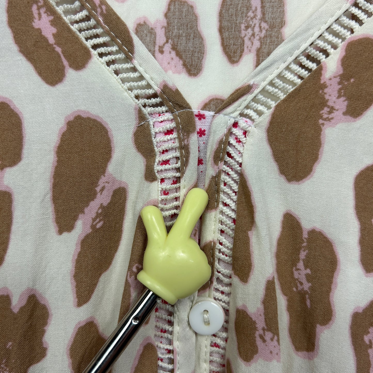 Cream cardigan with brown polka dots detail view of zipper