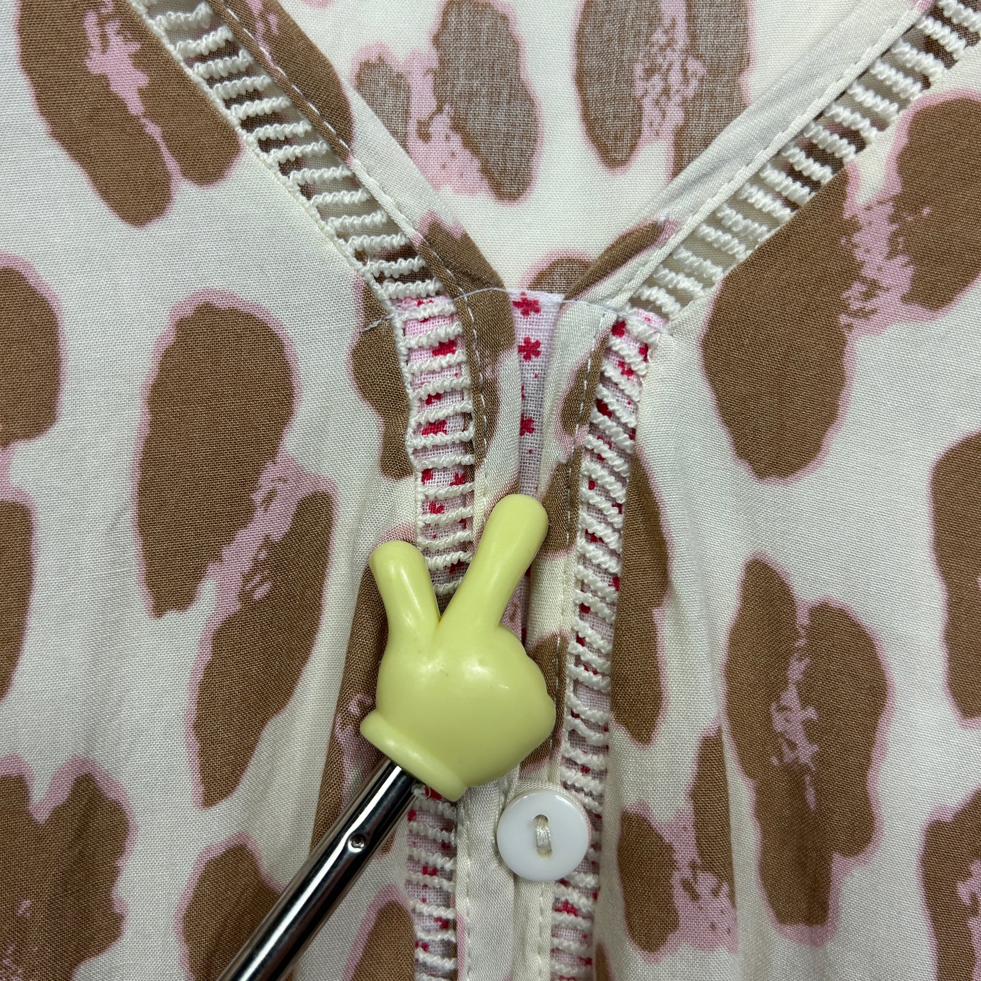 Cream cardigan with brown polka dots detail view of zipper