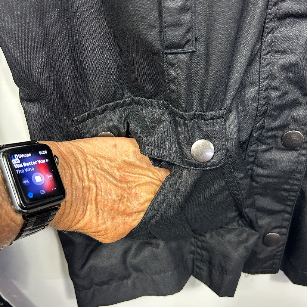 Black jacket detail view with wooden gloves