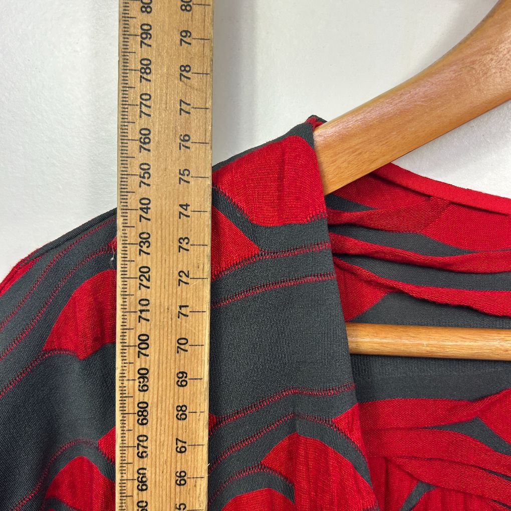 Red and black striped long sleeve top detail view