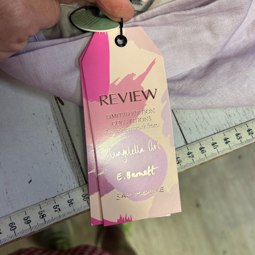 Pink and cream clothing tag detail view