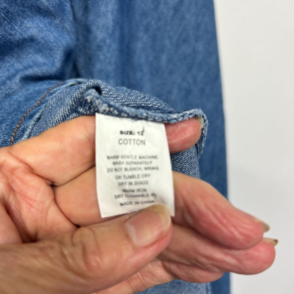 Blue denim shirt label detail view