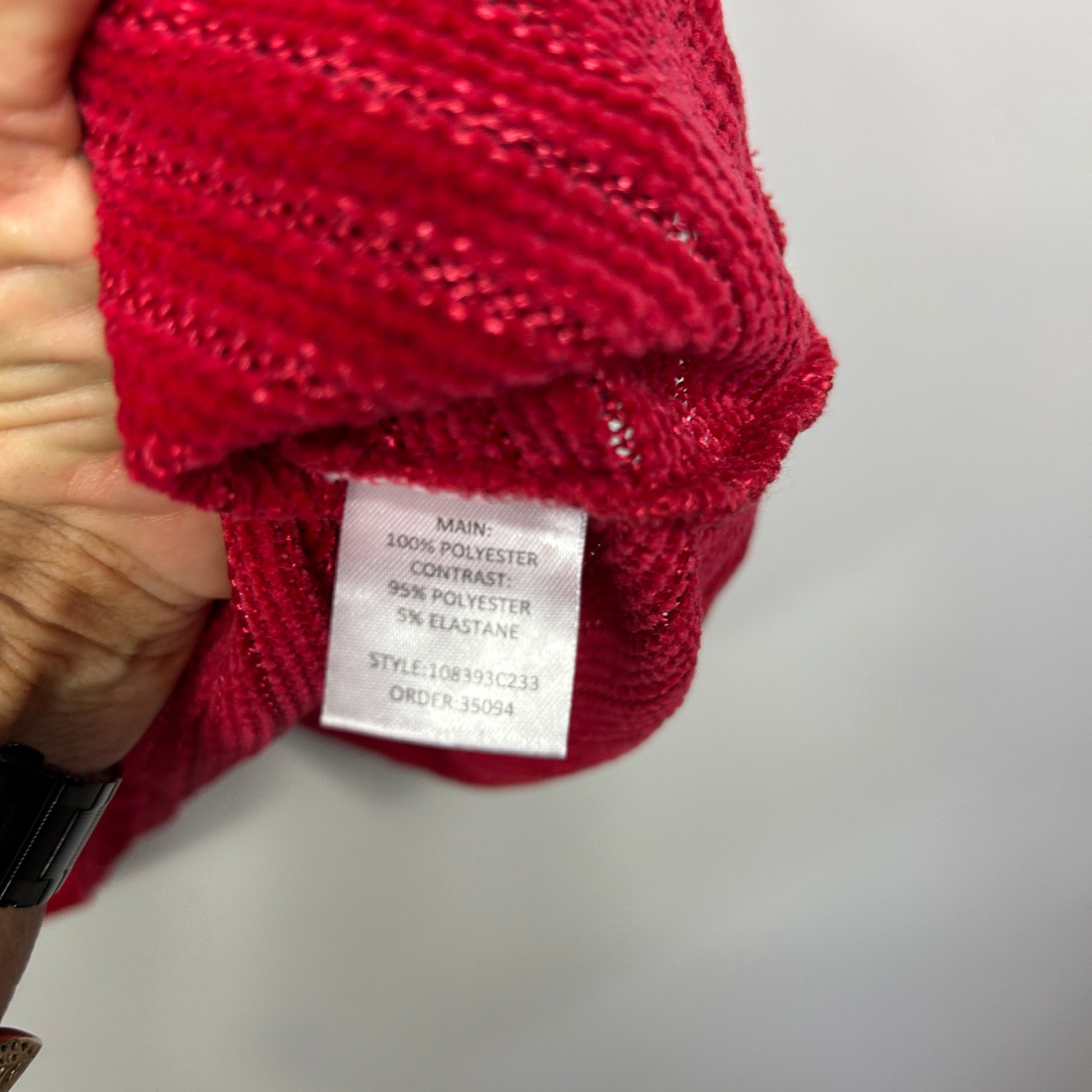 Red knit jumper label detail view
