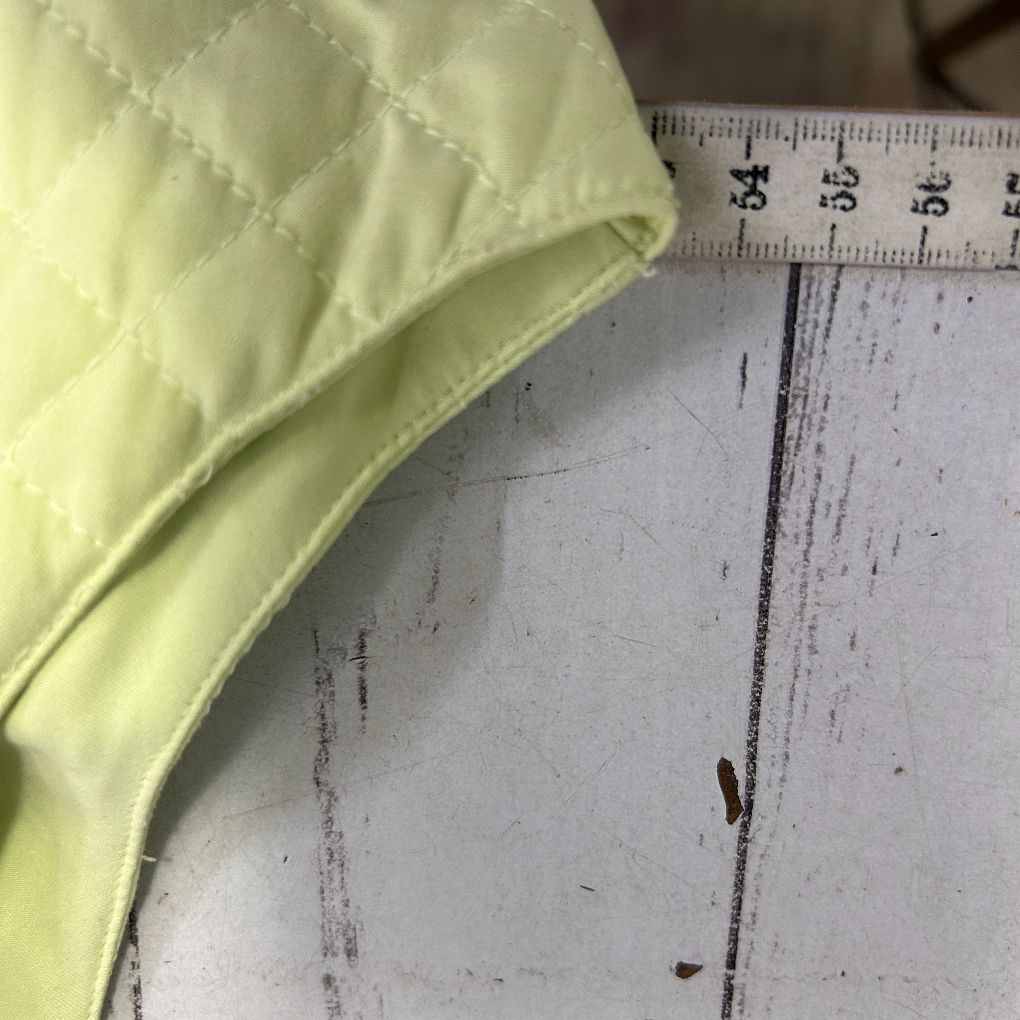 Yellow quilted vest detail view