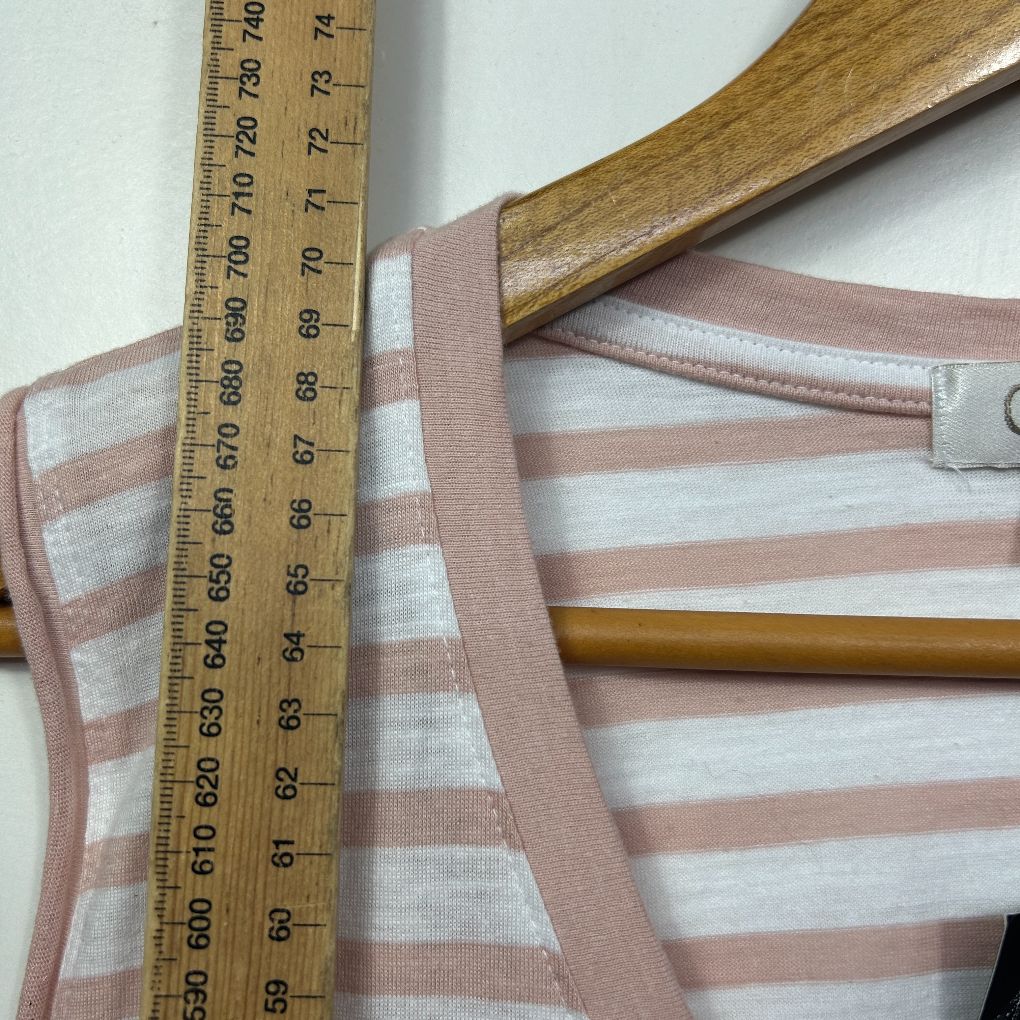 Pink and white striped top detail view with measuring tape