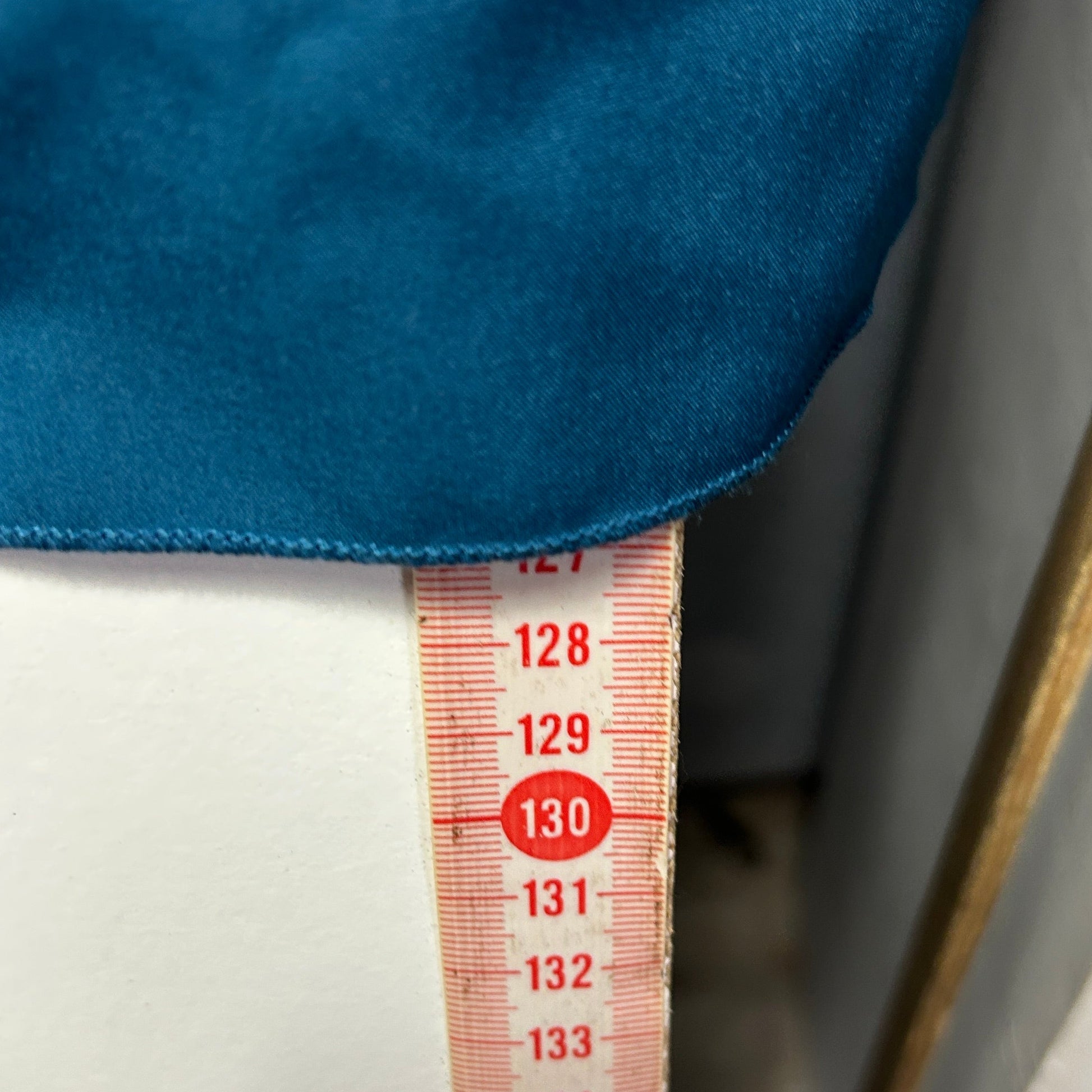 Blue fabric with measurement tape detail view