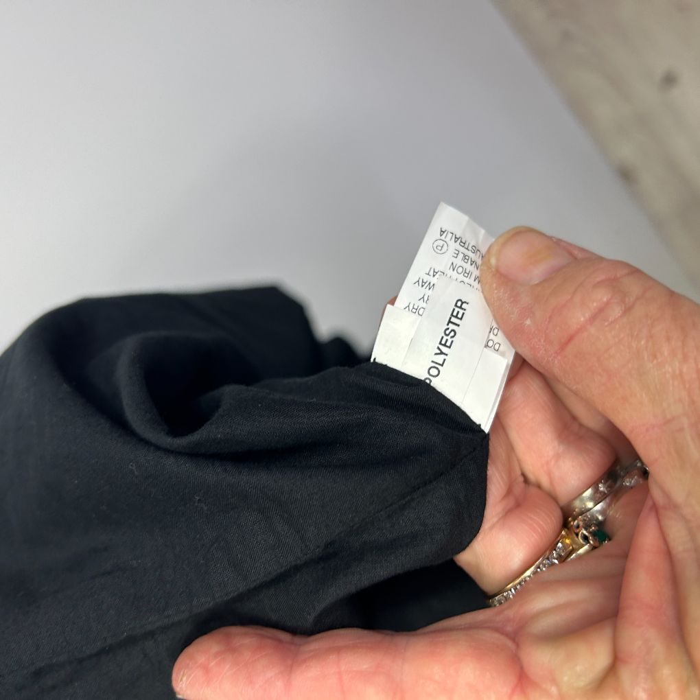Black garment label detail view