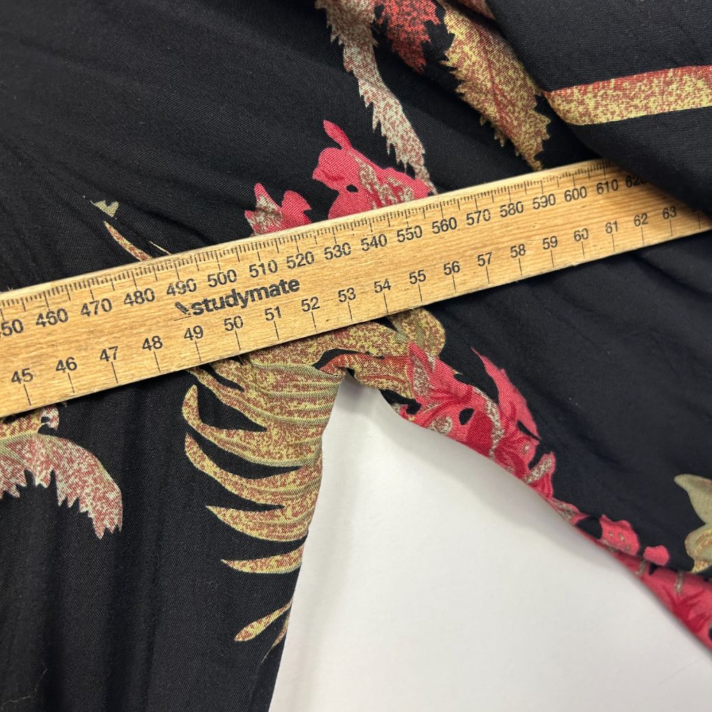 Black fabric with gold and red floral embroidery detail view