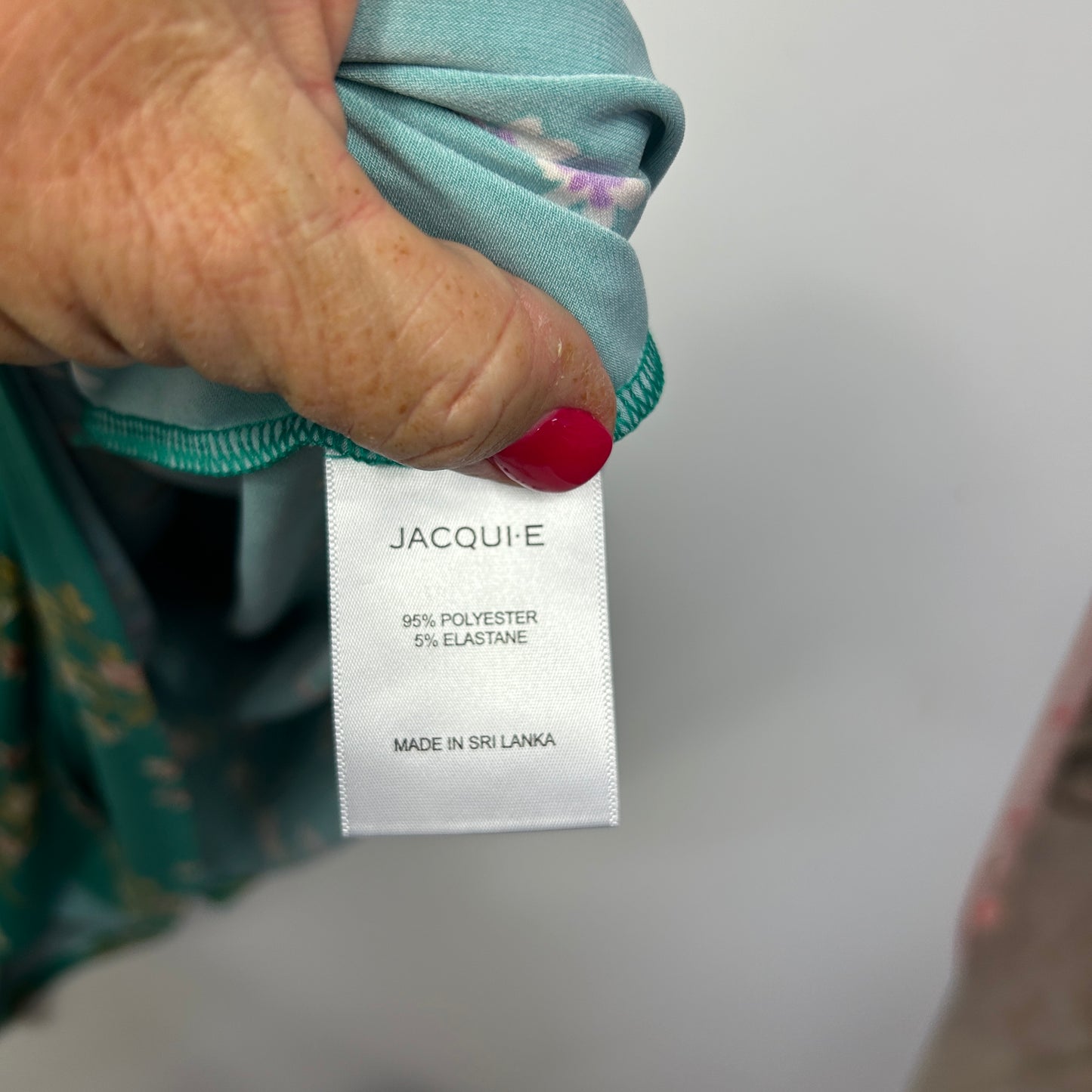 Green scarf detail view showing label