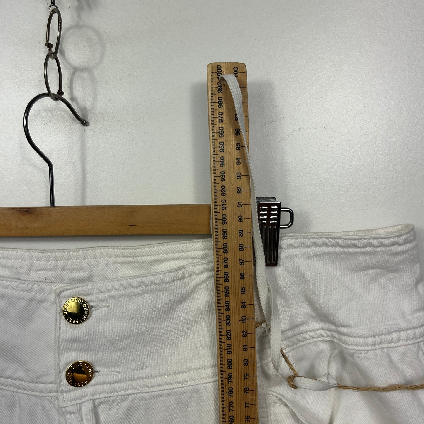 White pants detail view with measuring tape