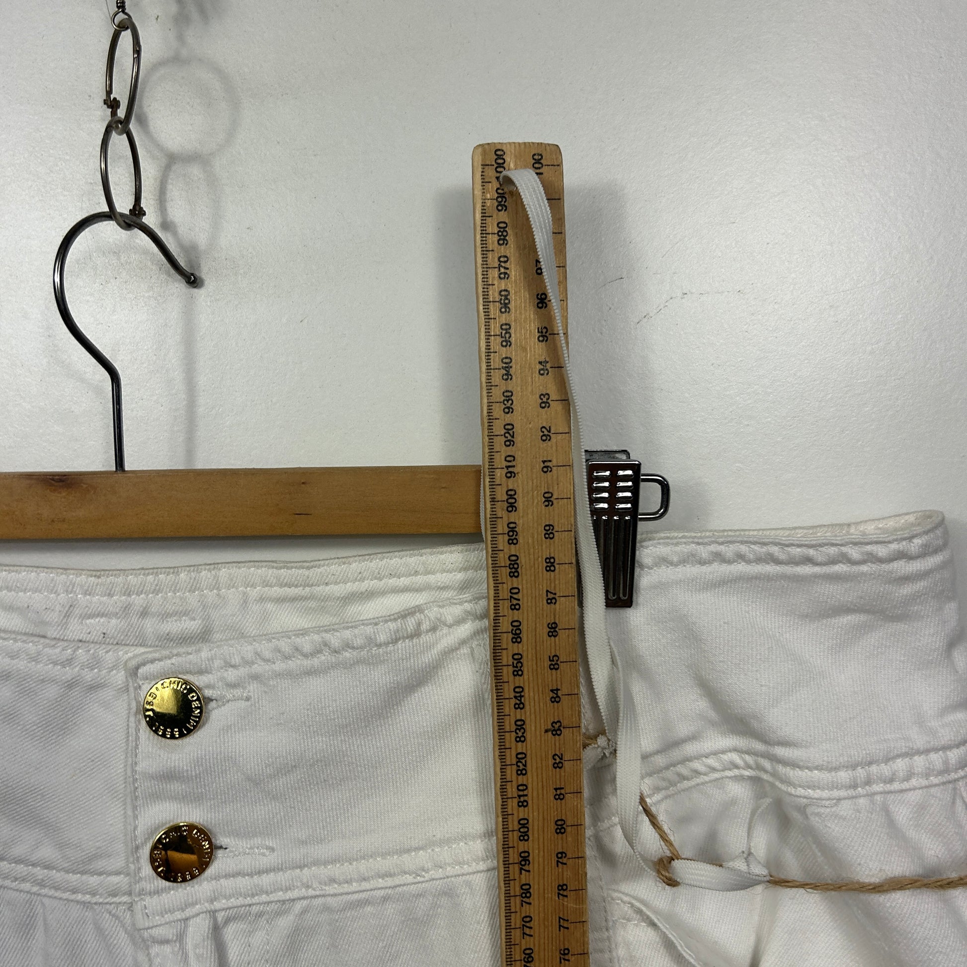 White pants detail view with measuring tape
