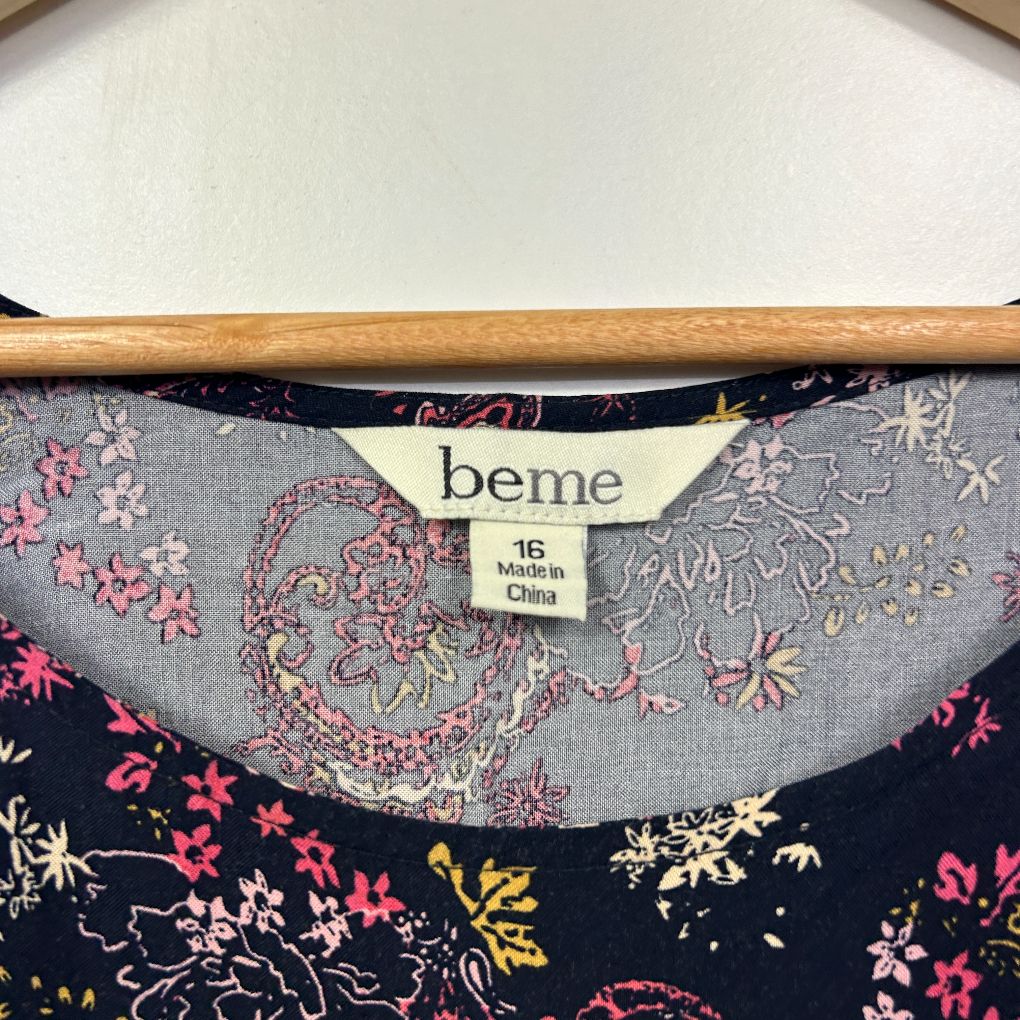 Navy floral top label and neckline detail view