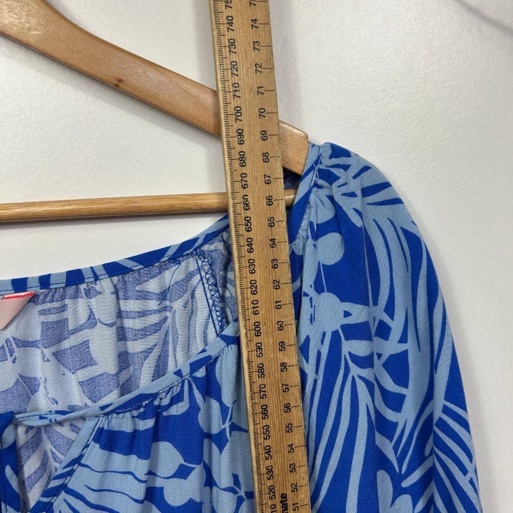 Blue floral top detail view with measuring tape