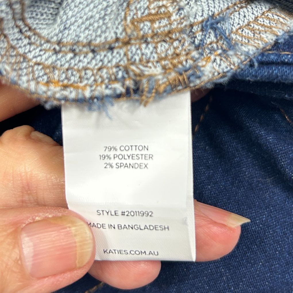 Beige and navy knit garment label detail view