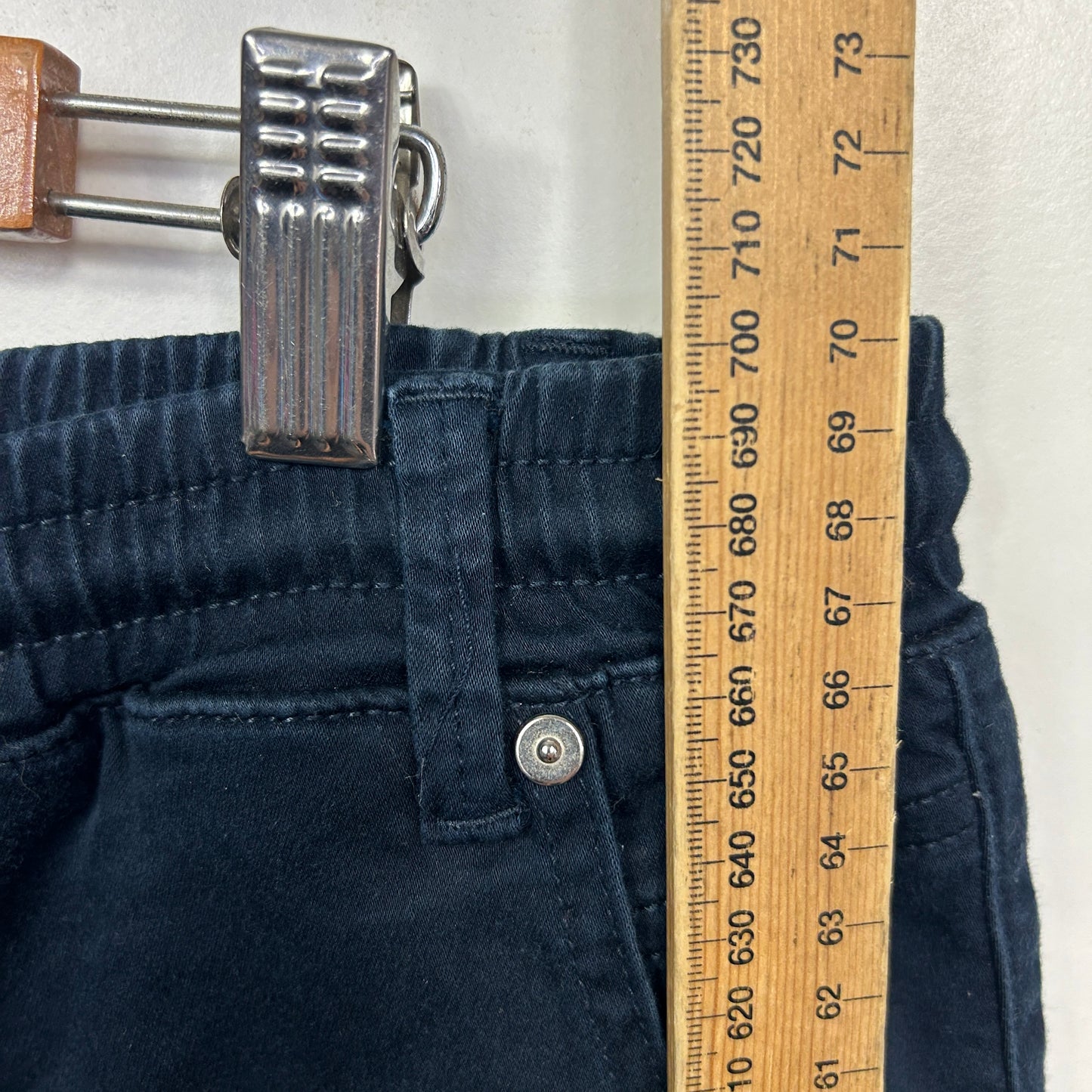 Navy pants detail view with measuring tape