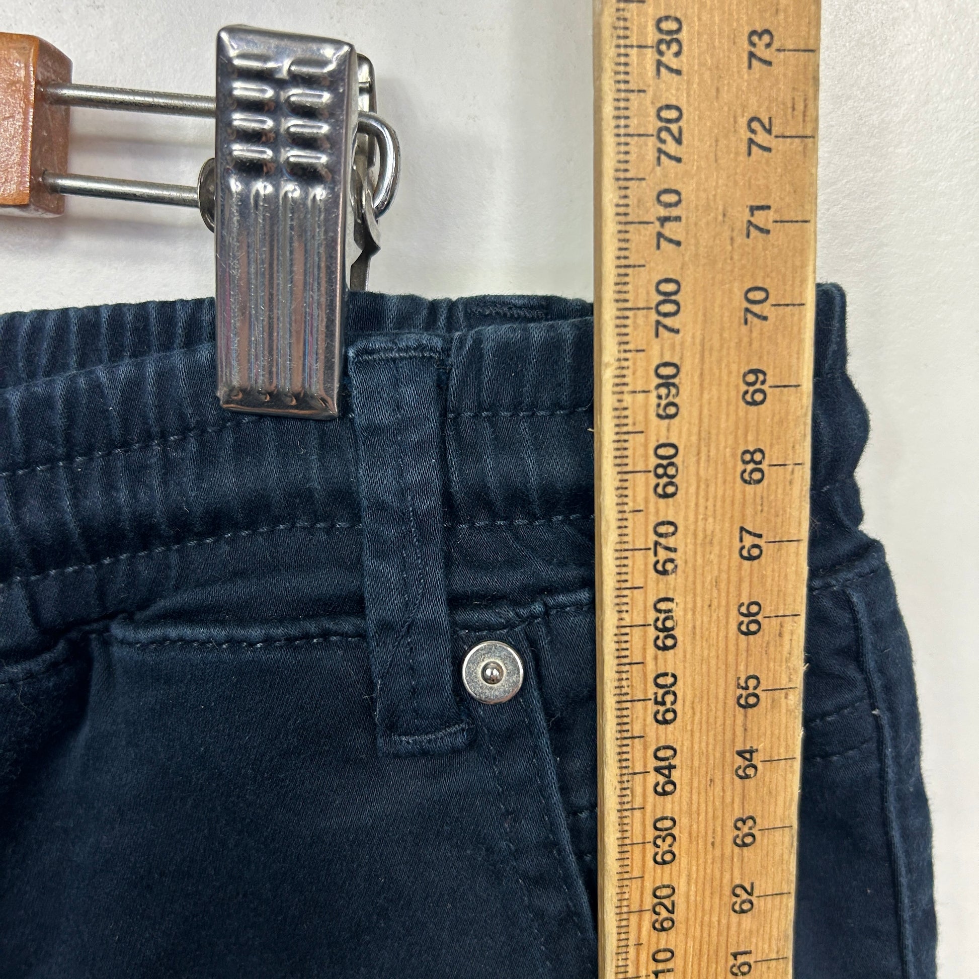 Navy pants detail view with measuring tape