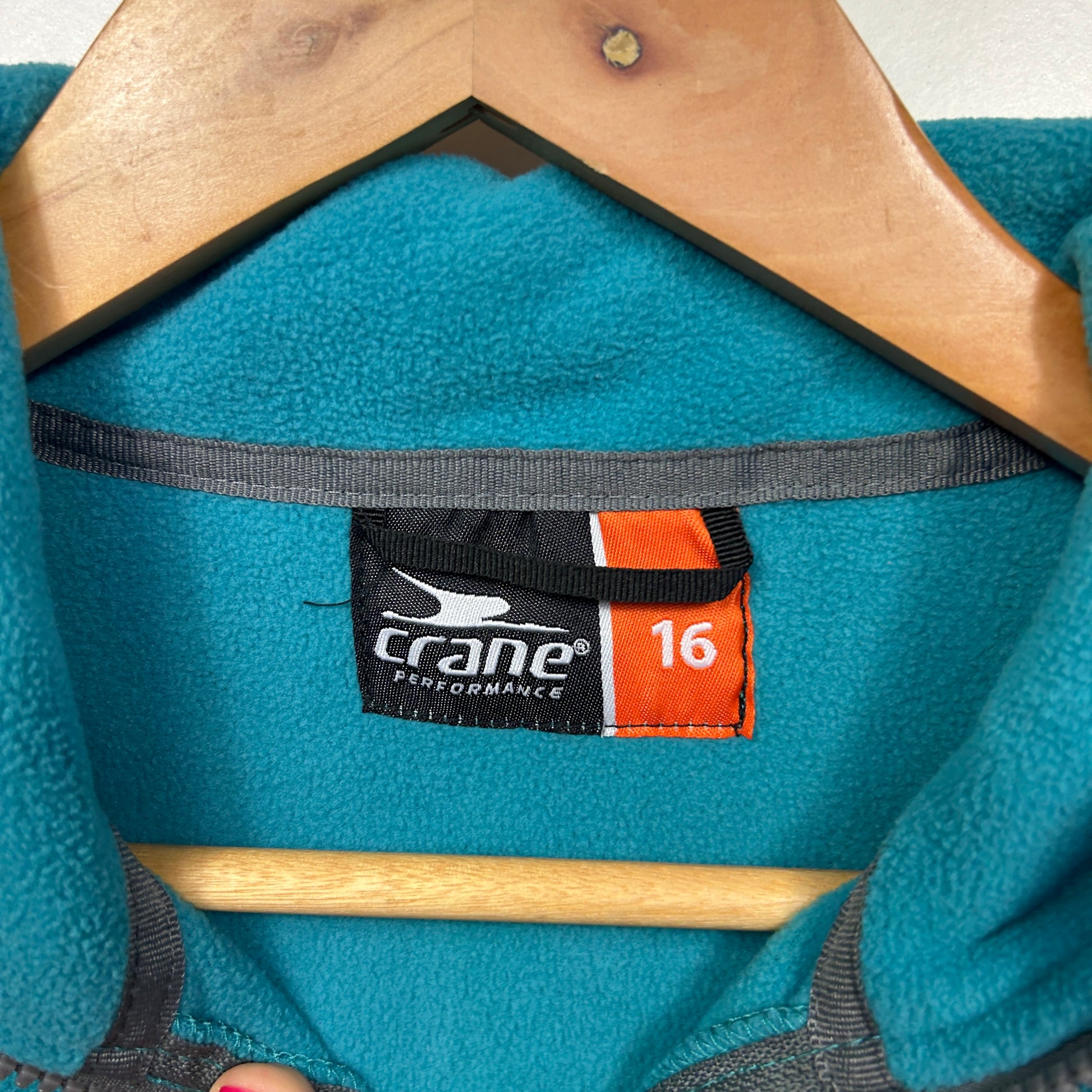 Teal fleece jacket label detail view