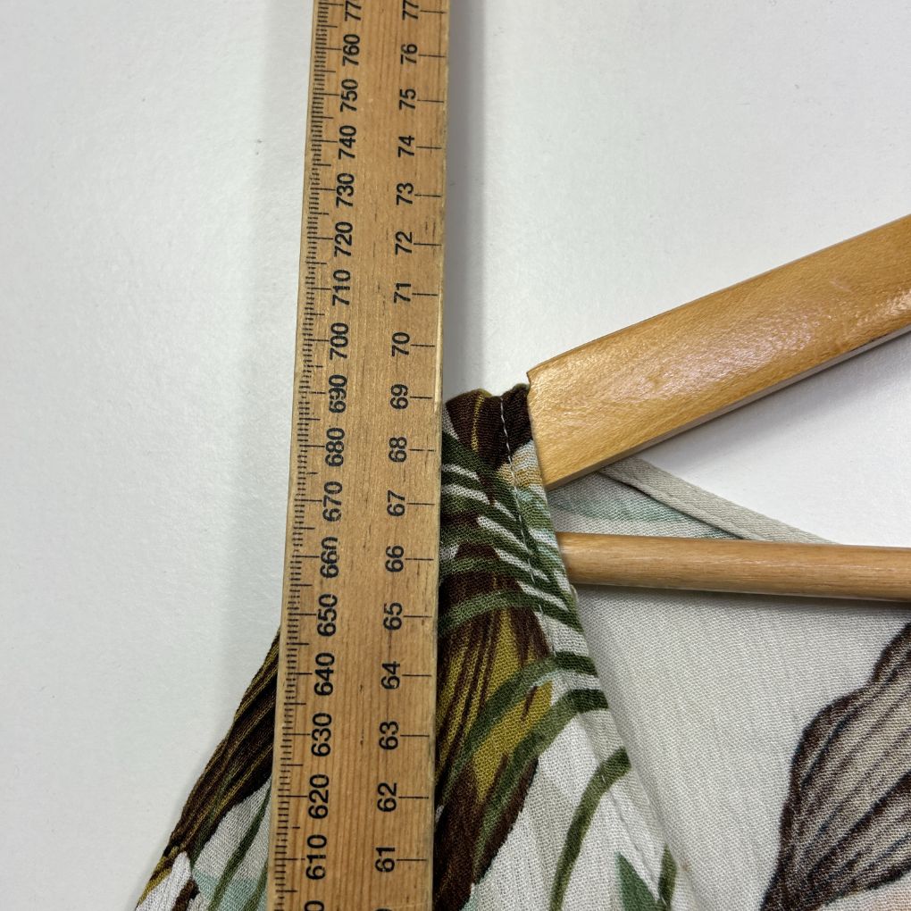 Measuring tape detail view showing wooden handles and botanical illustration