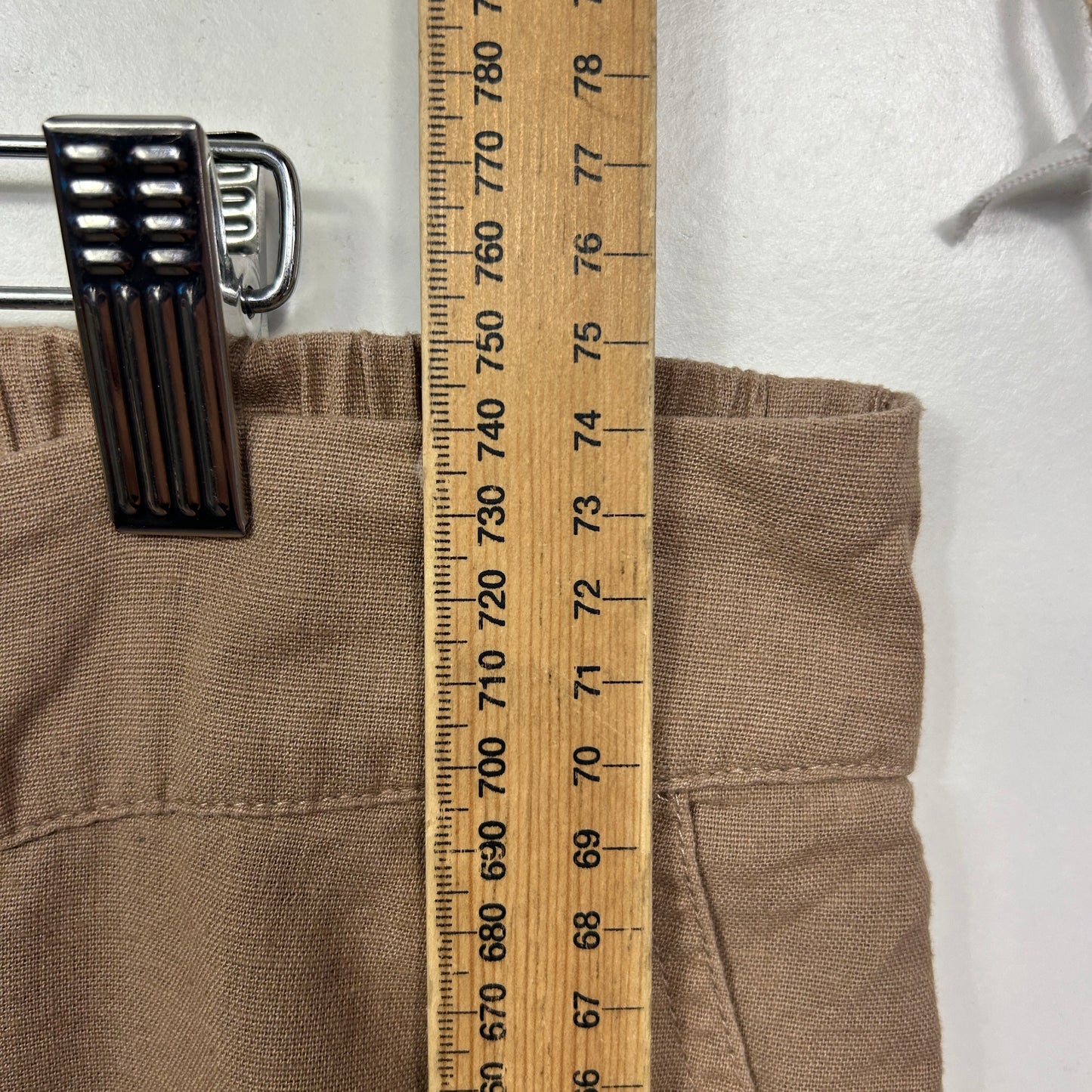 Beige pants front view with measurement ruler