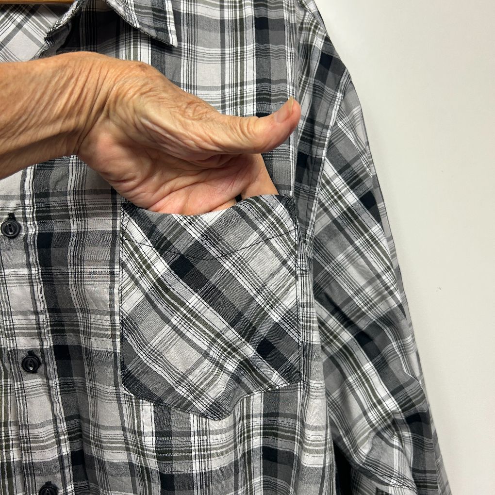 Grey and black plaid shirt detail view showing pocket