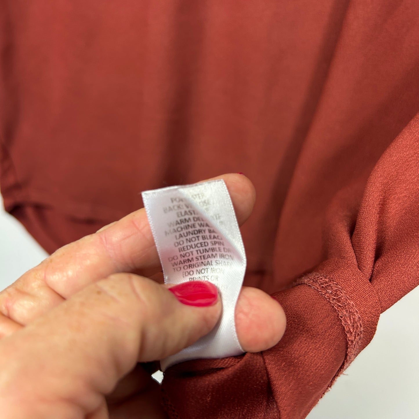 Rust brown garment label detail view