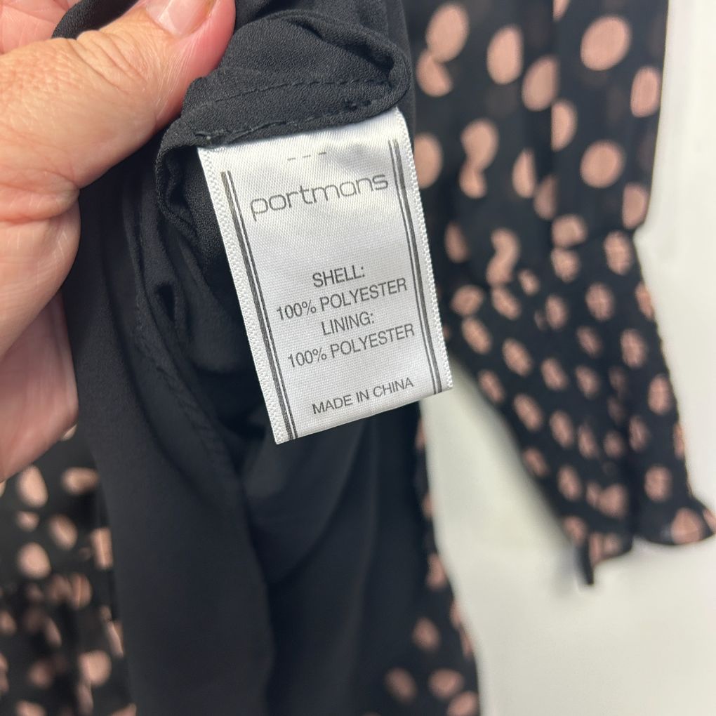 Black top with polka dot pattern label detail view