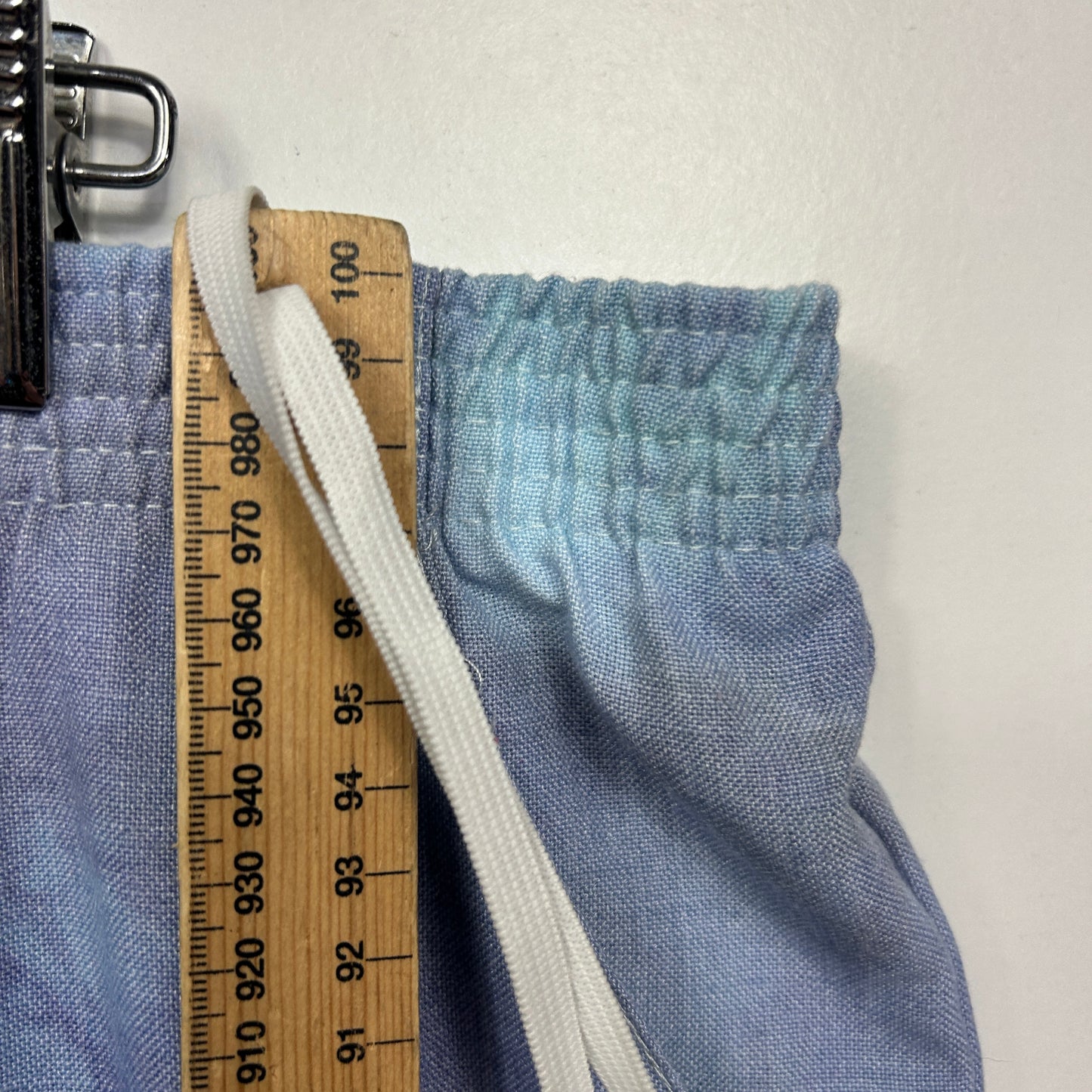 Blue fabric detail view with measuring tape