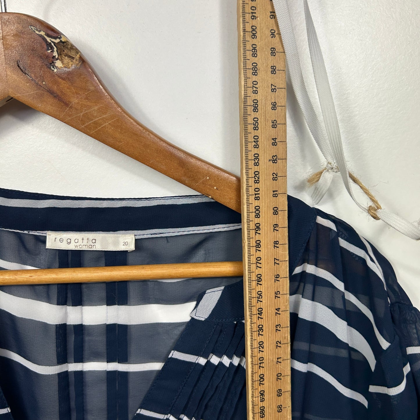 Navy striped long sleeve top front view on wooden hanger