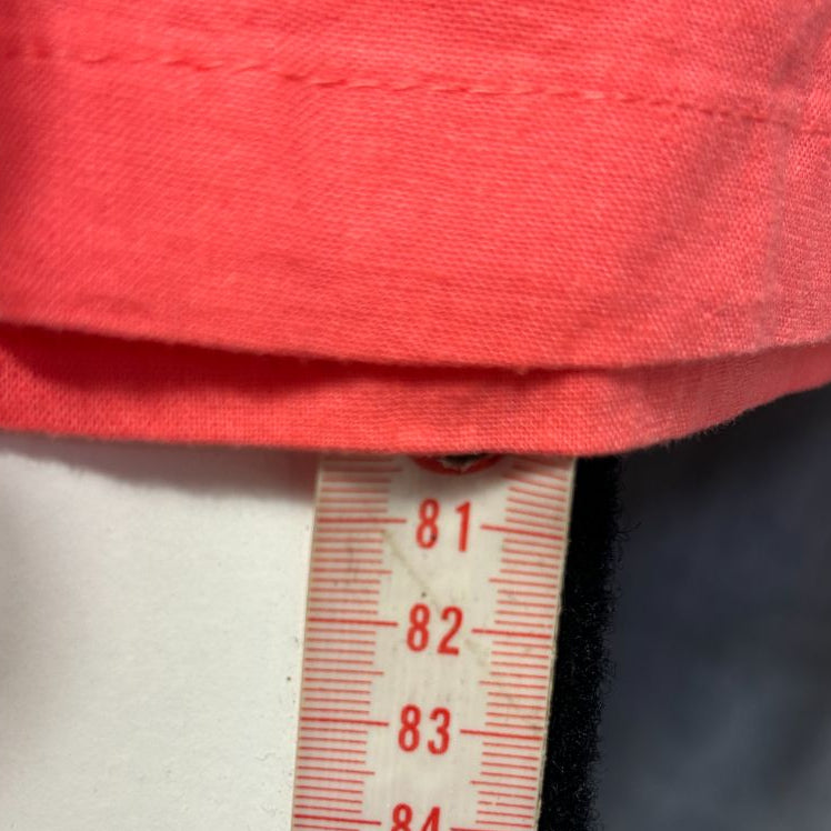 Red top with measurement tape detail view