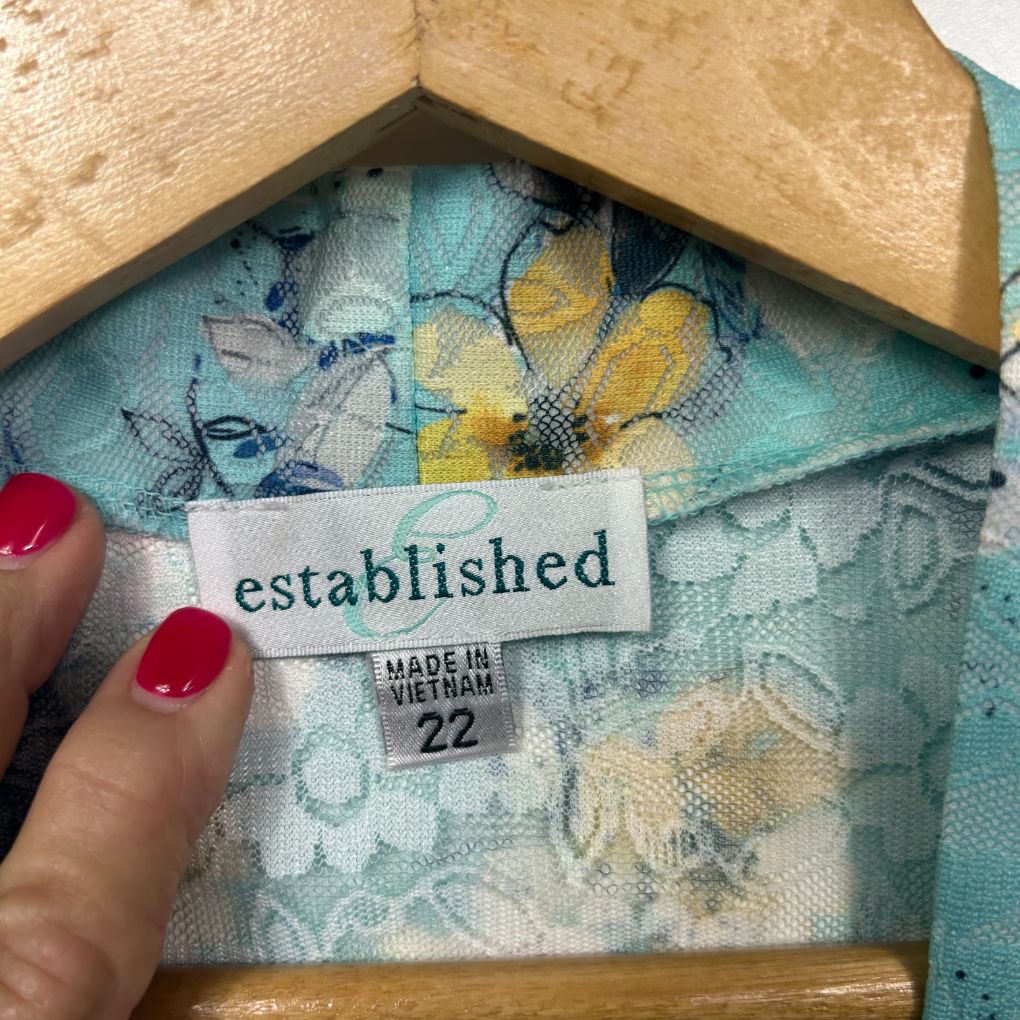 Established brand label detail showing size 22 made in Vietnam on blue floral fabric