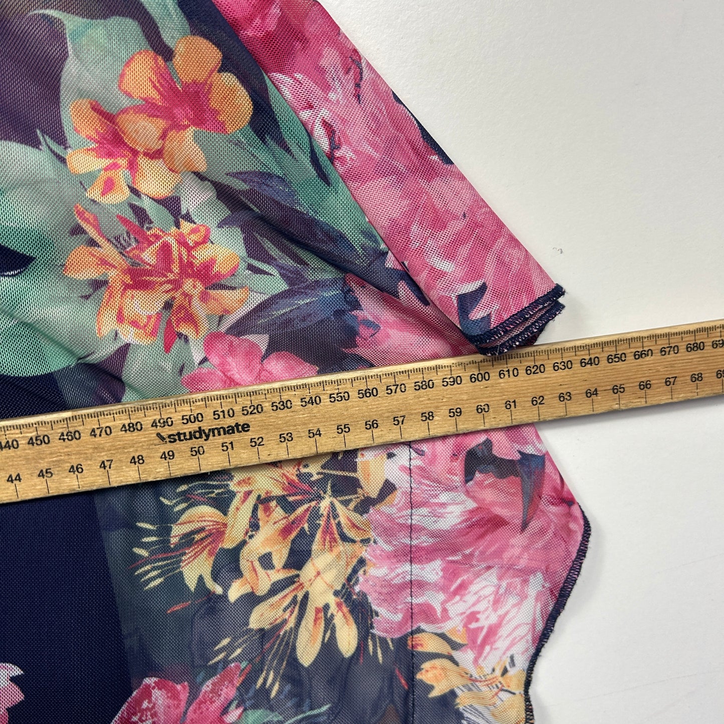 Floral dress detail view with measuring tape