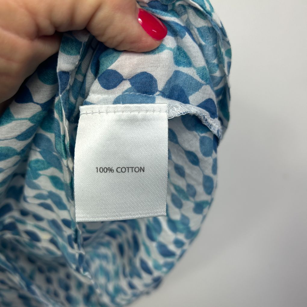Blue and white patterned fabric label detail showing 100% cotton content