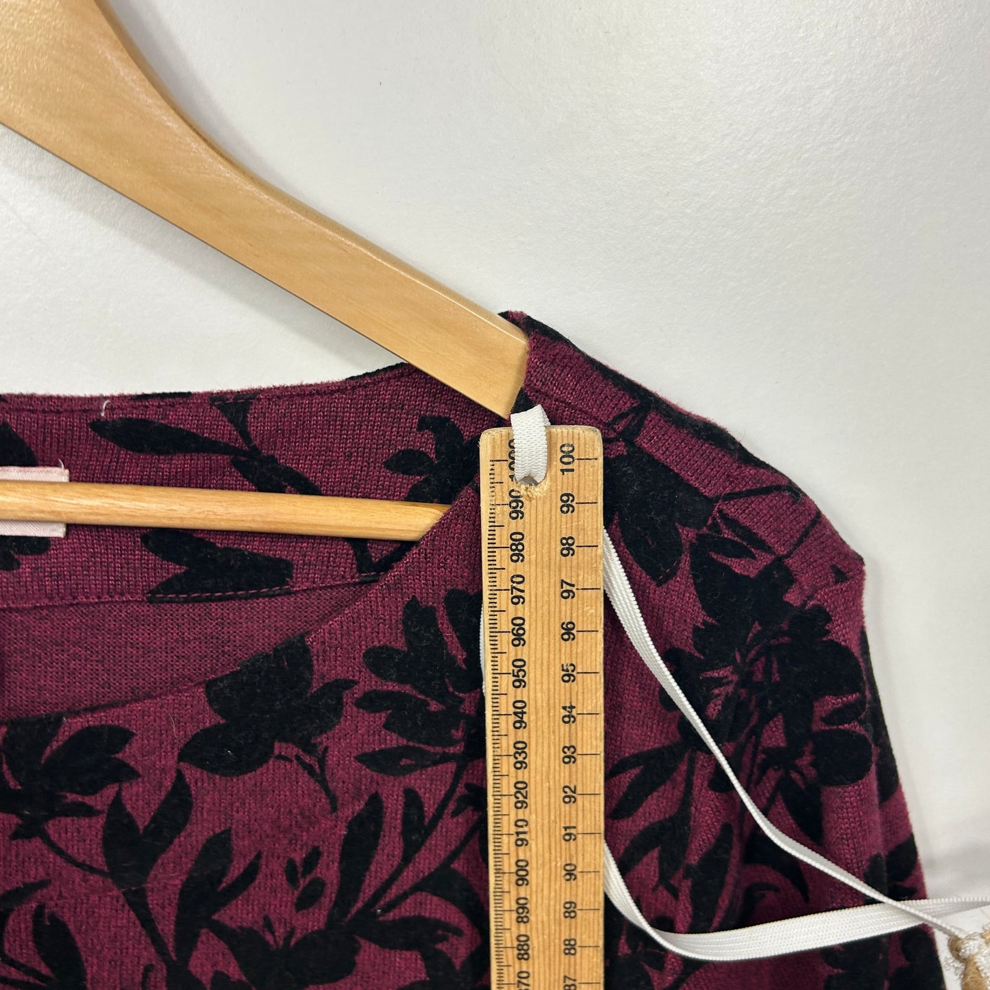 Burgundy floral top front view with measuring tape detail