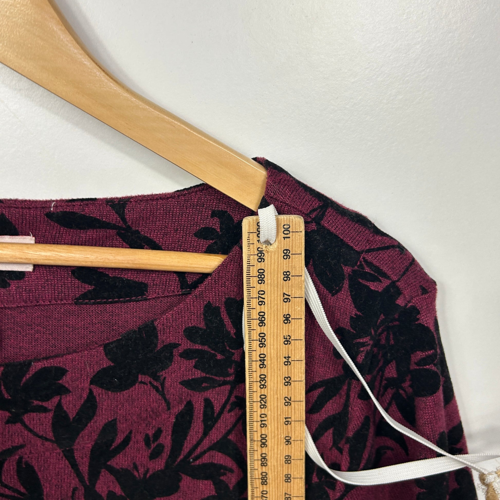 Burgundy floral top front view with measuring tape detail