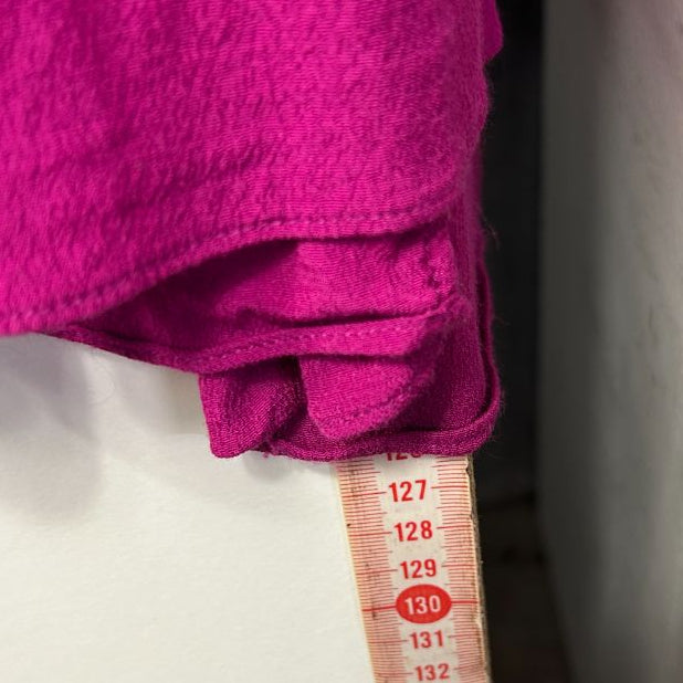 Pink jumper detail view with measuring tape