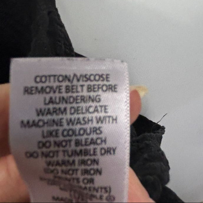 Black jumper care label detail view