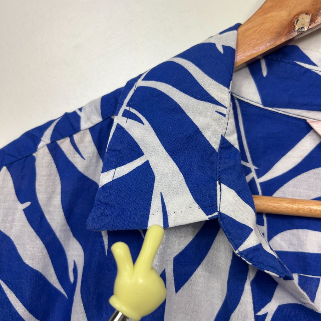 Blue and white striped shirt detail view on hanger