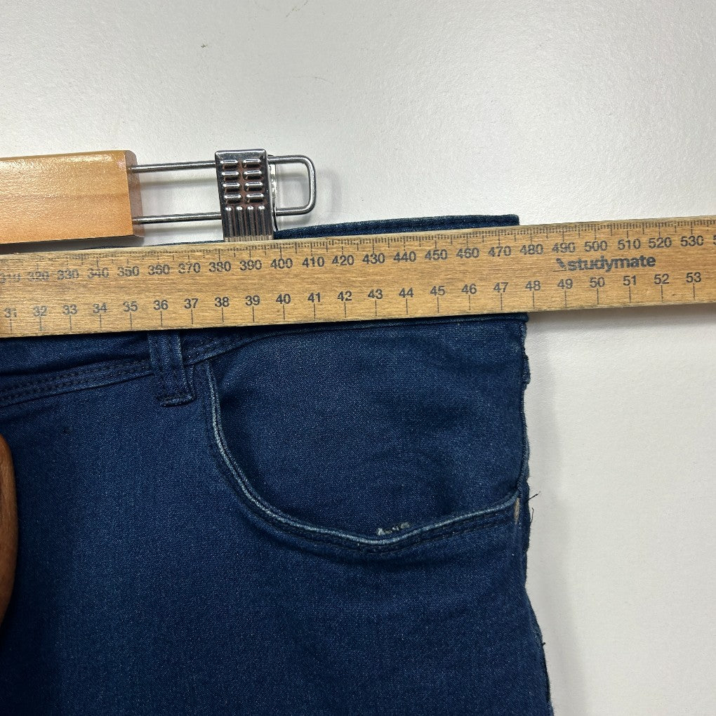 Blue jeans with measuring tape and belt detail view