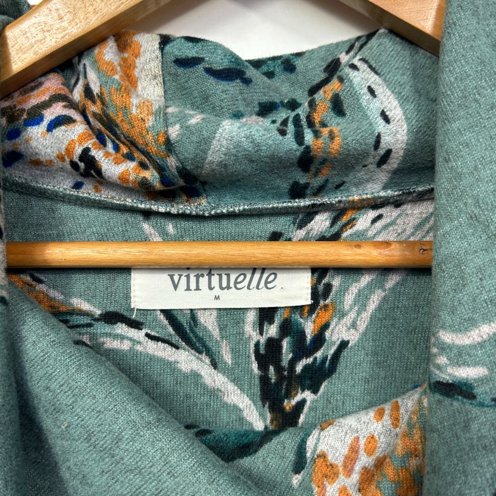 Green jumper with floral pattern detail view