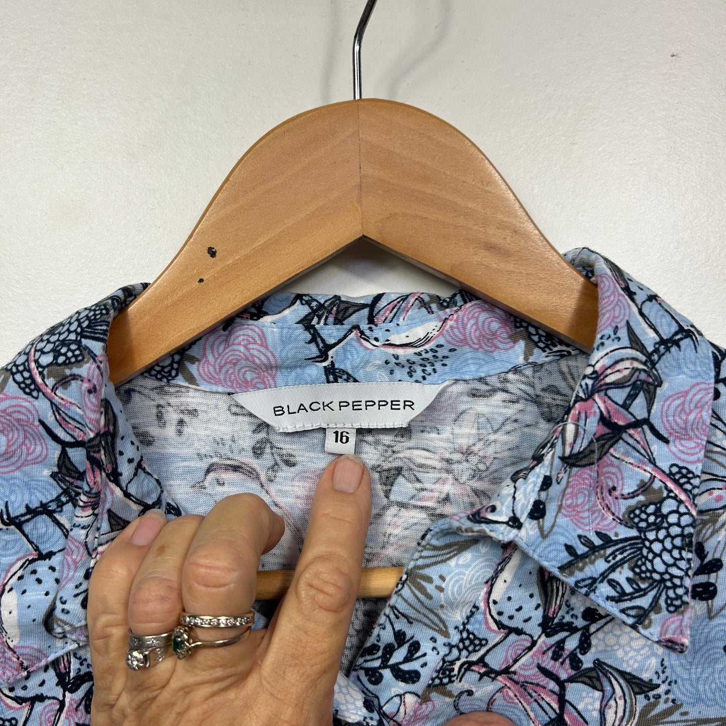 Blue floral shirt front view on wooden hanger