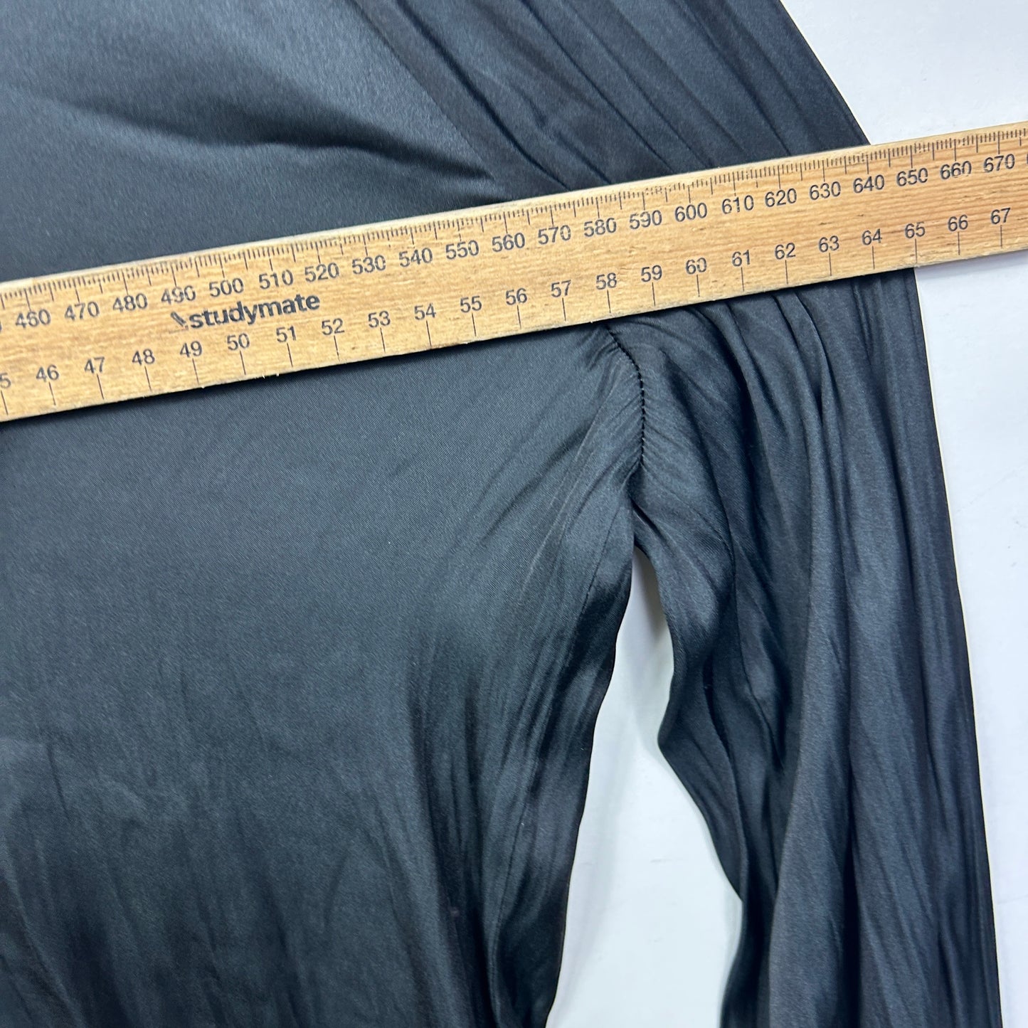 Grey pants detail view with measuring tape