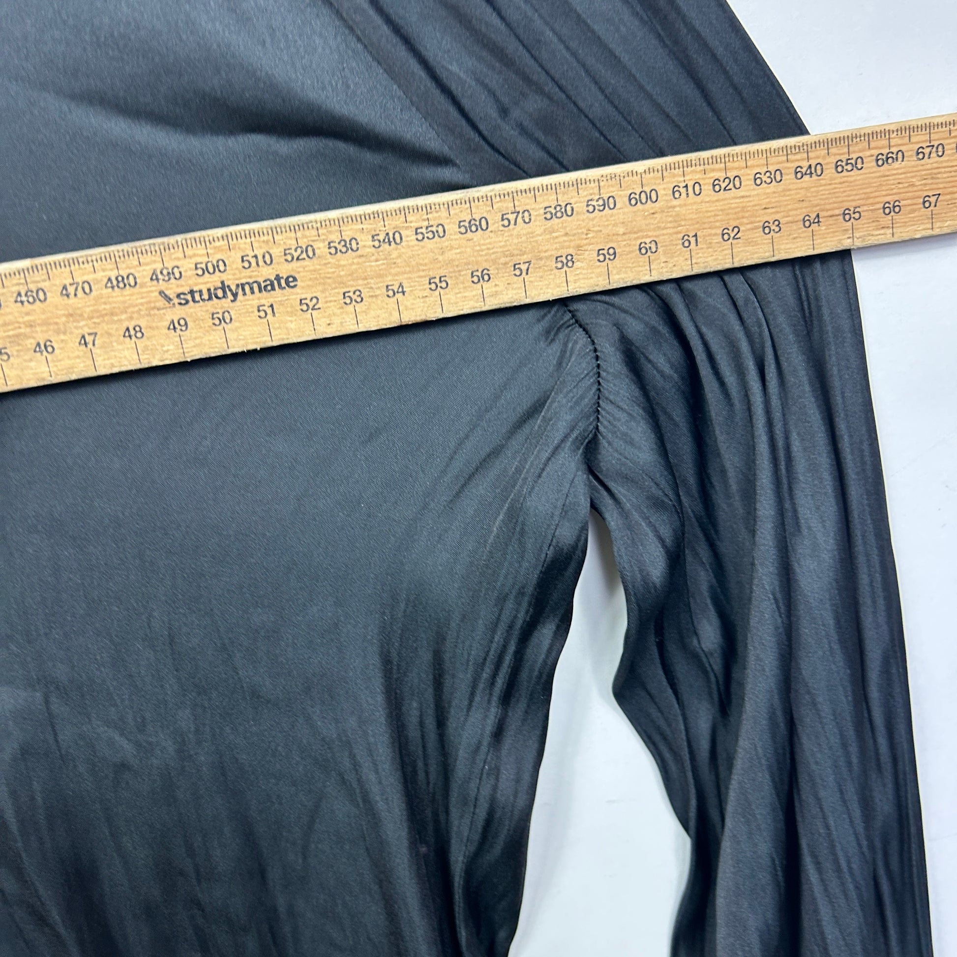 Grey pants detail view with measuring tape