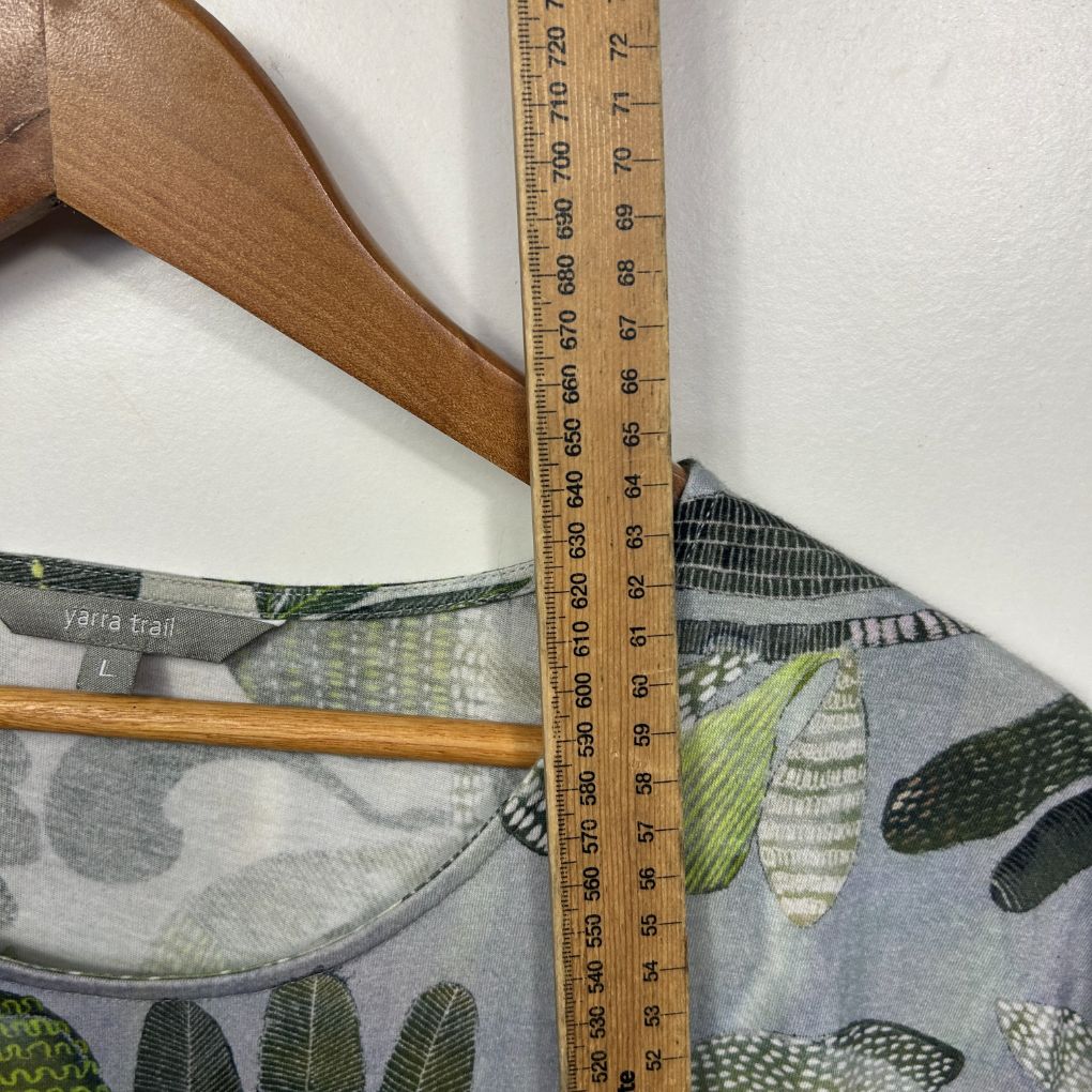 Blue floral dress detail view with ruler measurement