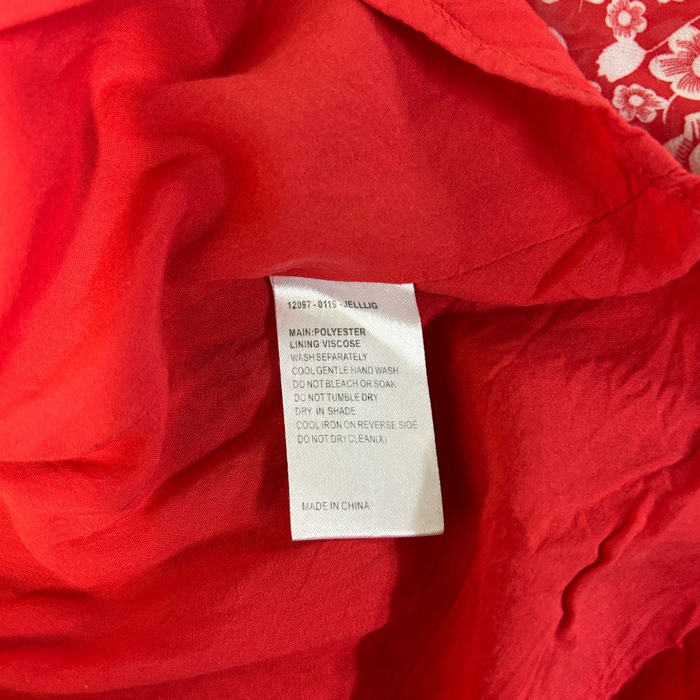 Red fabric with care label detail view
