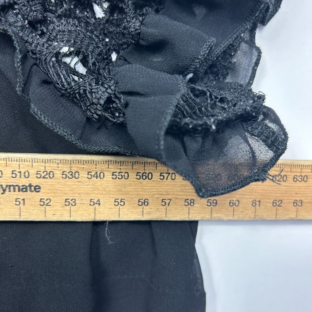 Black lace top detail view with measurement ruler