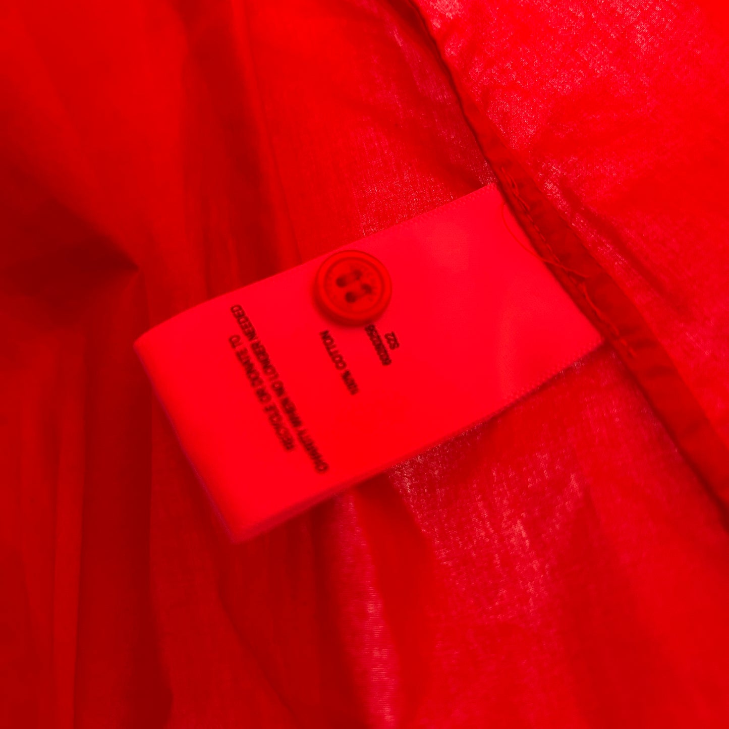 Red garment label detail view